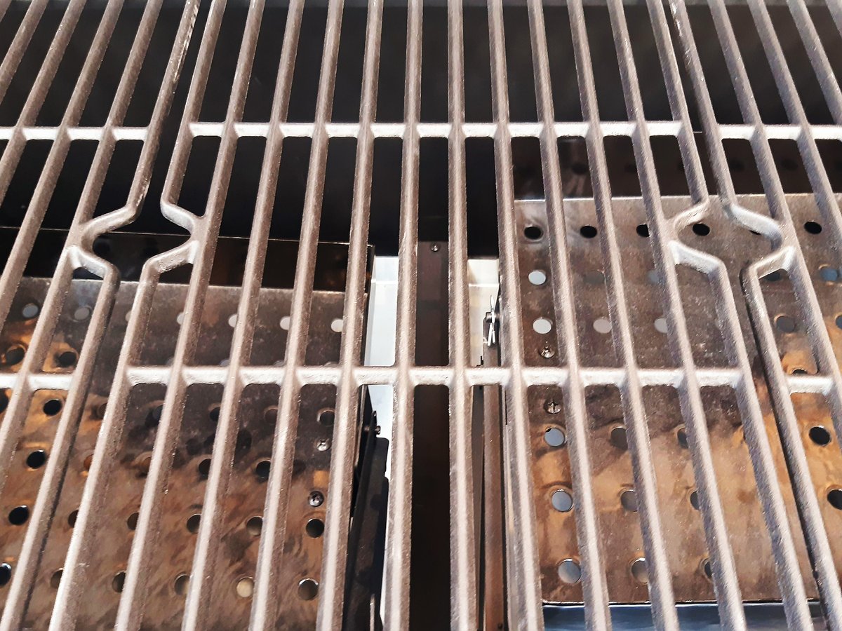 Close-up of a new barbecue grill, aluminum grill drawer, outdoor kitchen utensils